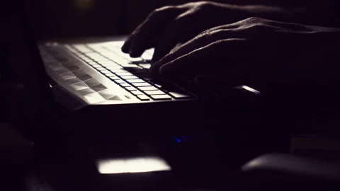 The guy is typing on the keyboard. Hacker. Male hands are typing the text Stock Footage 154451750