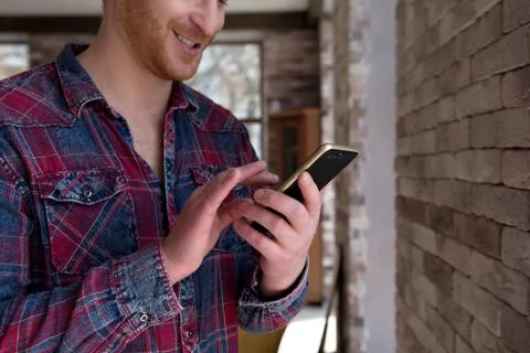 Guy typing on smartphone. Stock Photos