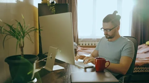Guy typing text at home at the computer, works at home Stock Footage 239323594
