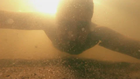 The guy under the water looks at the object emotionally. Stock Footage 157921317