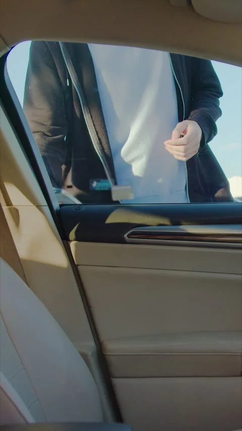 Guy unlocks door and gets into rented vehicle starting trip Stock Footage 300545195