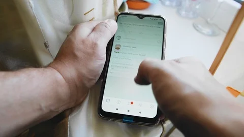 The guy unlocks the phone and clicks on the screen while working with the gadget Stock Footage 129983076