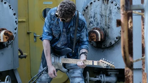 Guy use electric guitar on quay ship close up arms playing cool rock music 4K. Stock Footage 120434563