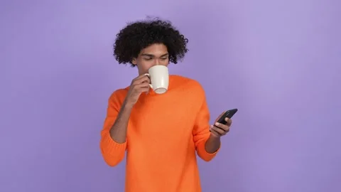 Guy use gadget share comment drink latte isolated bright color background Stock Footage 168689577