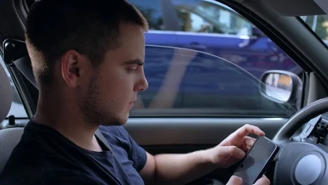 Guy use smartphone in car. Stock Footage 114956667