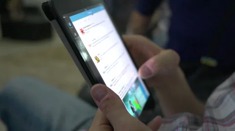 Guy user of social networks via tablet browsing news feed Stock Footage 39350331