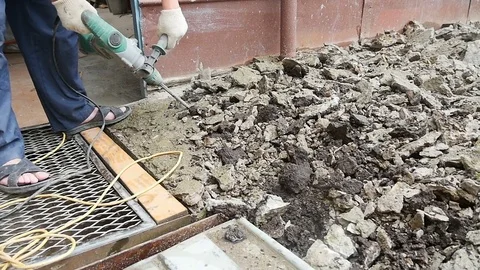 Guy uses a jackhammer to repair Video stock 80278655