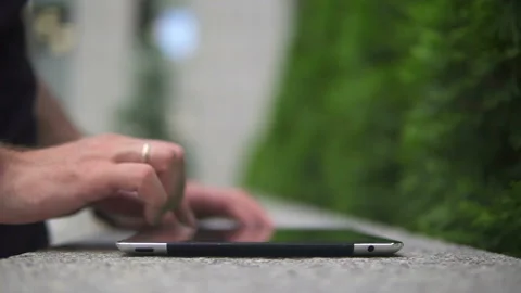 The guy uses the tablet on the street, only hands are visible Stock-Footage 113405185