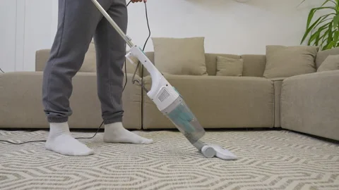 Guy uses vacuum cleaner to keep clean Stock Footage 237286919