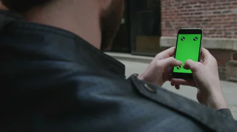 Guy Using green screen iphone Stock Footage 59775654