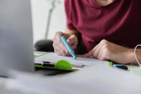 Guy using highlighter his papers Stock Photos