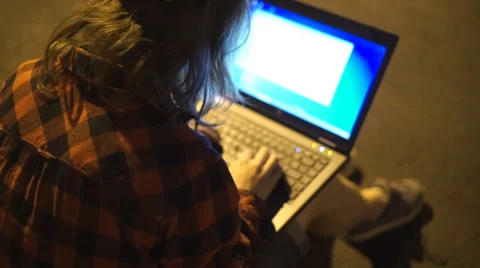 Guy using his laptop at nigth on the street Stock Footage 67501577