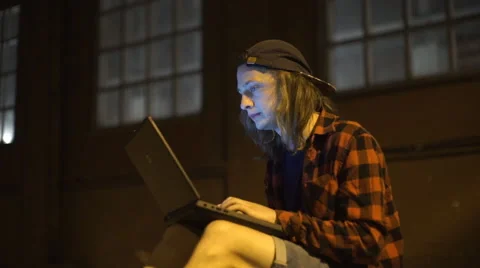 Guy using his laptop at nigth on the street Stock Footage 67501581