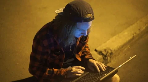 Guy using his laptop at nigth on the street Stock Footage 67501988