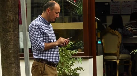 Guy using his mobile in a street Stock Footage 42141184