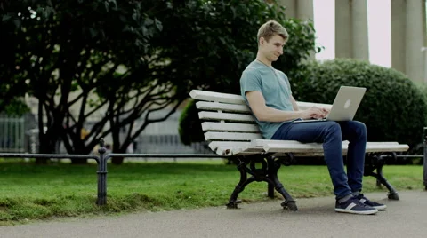 Guy using laptop outdoor Stock Footage 68857271