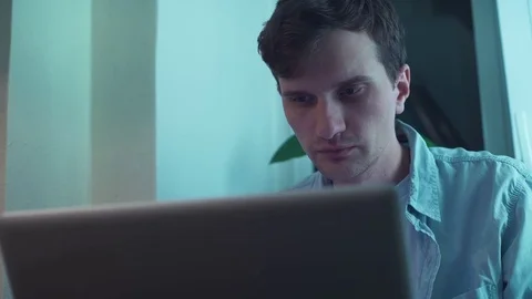 Guy using notebook computer sitting near window Stock Footage 83871123