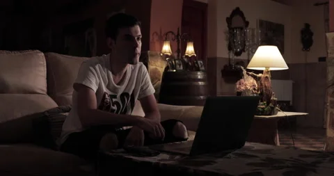 Guy using remote control turn off the TV while sitting on sofa Stock Footage 207137230