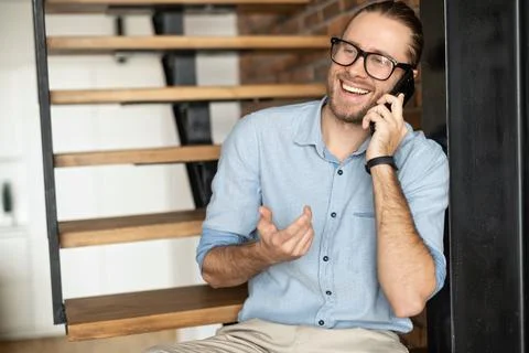 A guy is using smartphone sitting on the stairs Stock Photos