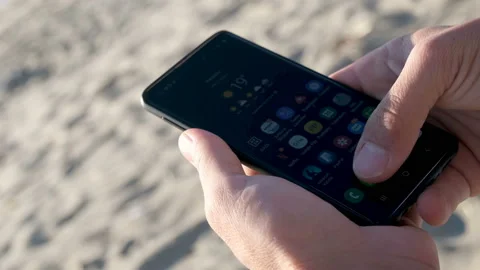 Guy using smartphone for social media and chat on sunset sea light,cell Stock Footage 141769981