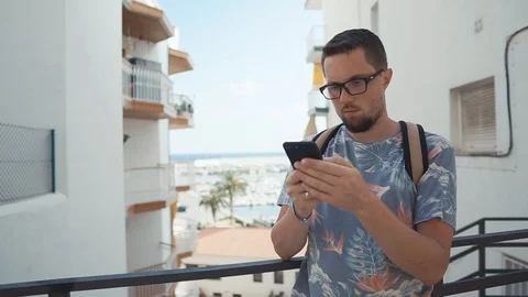 Guy using smartphone on vacation. Stock Footage 96859415