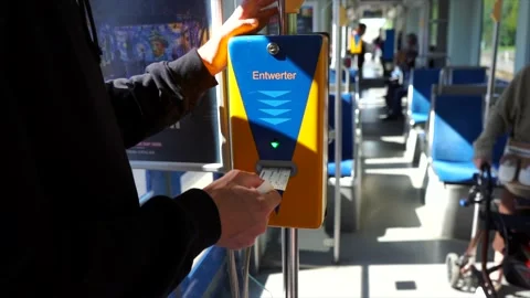 Guy validating his ticket in a public transport. Tram in Leipzig, Germany. Stock Footage 145964327
