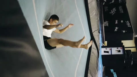 The guy is very cool jumping on a trampoline and makes dynamic coups Stock Footage 158481350