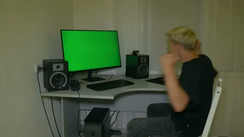 Guy is very happy with what is shown on the computer screen. Stock Footage 204946740