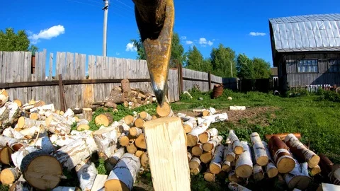 The guy vigorously chopping birch logs with a log splitter.Woodman. Stock Footage 110668539