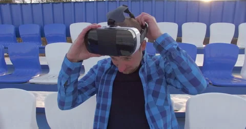 A guy in VR glasses looking around Stock Footage 62680822