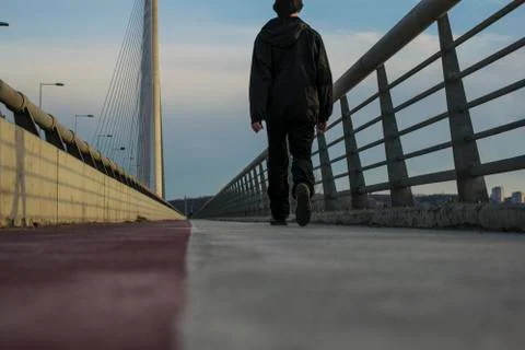 Guy walking on ada bridge in belgrade Stock Photos
