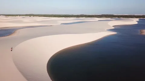 Guy walking alone in dunes of Lencois Maranhenses Video stock 168404291
