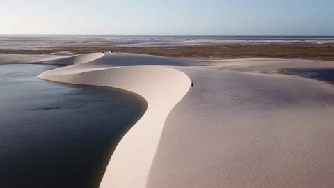 Guy walking alone in dunes of Lencois Maranhenses Video stock 168405406