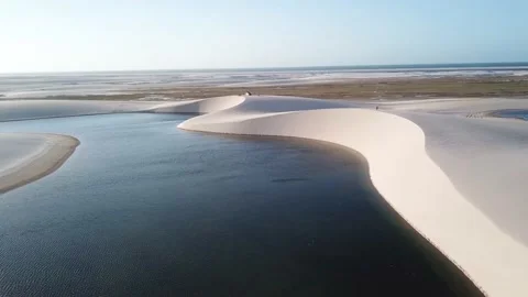 Guy walking alone in dunes of Lencois Maranhenses Stock-Footage 168407215