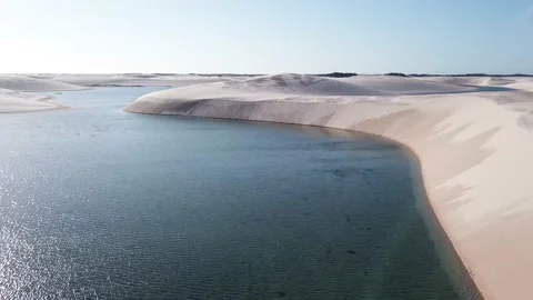 Guy walking alone in dunes of Lencois Maranhenses Stock Footage 168424057