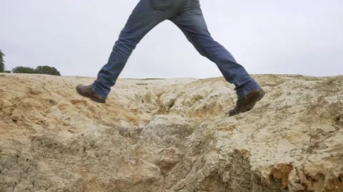 Guy walking in a arid ground Stock Footage 145544713