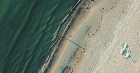 Guy walking at the beach ocean water topshot aerial straight down waves sand 스톡 동영상 153494991