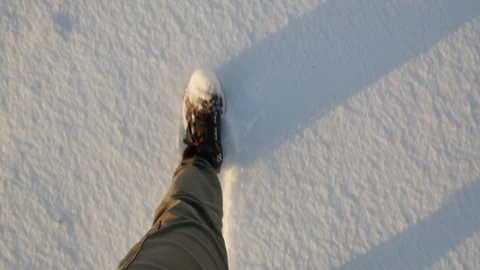 The guy is walking in boots on fresh snow. feet in the frame Stock Footage 125696363