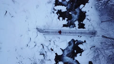 The guy is walking on the bridge over the river. Stock Footage 147370655