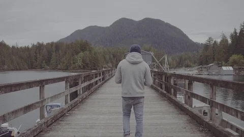 Guy walking on a dock Stock Footage 81395462