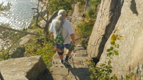 Guy walking down the stairs at Odderøya, Kristiansand - Norway Stock Footage 71353321