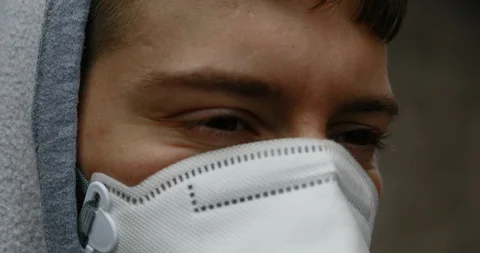 Guy walking in an hostile city with a face mask Stock Footage 129481389