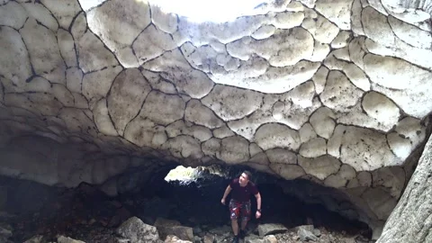 The guy is walking in an ice cave. Video stock 139961821