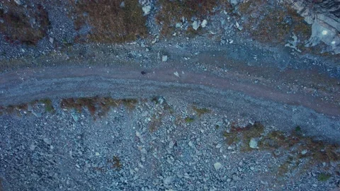 The guy is walking in the mountains along gorge 스톡 동영상 215606868