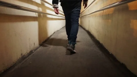 Guy is walking right down the corridor on the street Stock Footage 80468364