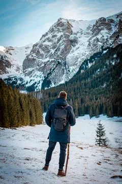 A guy with a walking stick in the mountain Foto stock