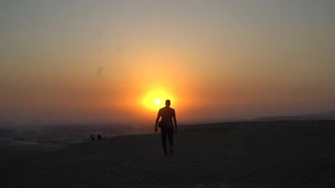 Guy walking at the sunset Stock Footage 201602802
