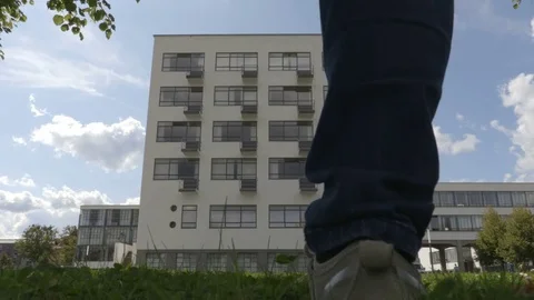 Guy is walking toward the Bauhaus building. September 2017 Stock Footage 83633981