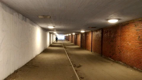 Guy Walking in a Tunnel Long Shot 動画素材 99534285