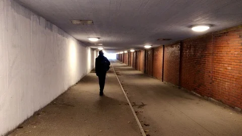 Guy Walking in a Tunnel Winter Time 動画素材 99534266